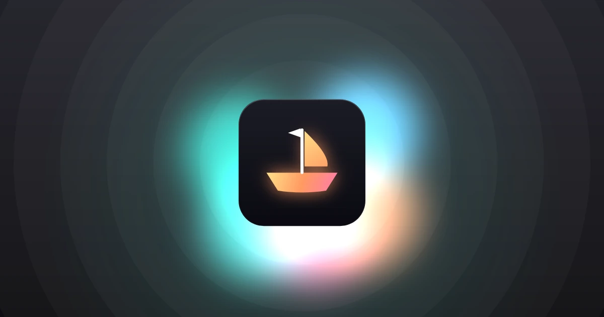 A glowing toy sailing boat with an orange hull, a sail and a white pennant on a dark glass tile, with teal and pink light spilling out from behind it.